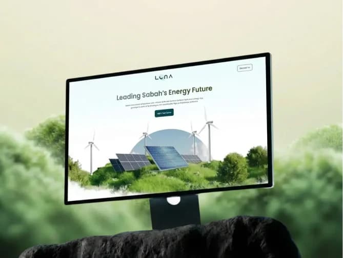 Luna website on a monitor: Leading Sabah's Energy Future, with solar panels and wind turbines